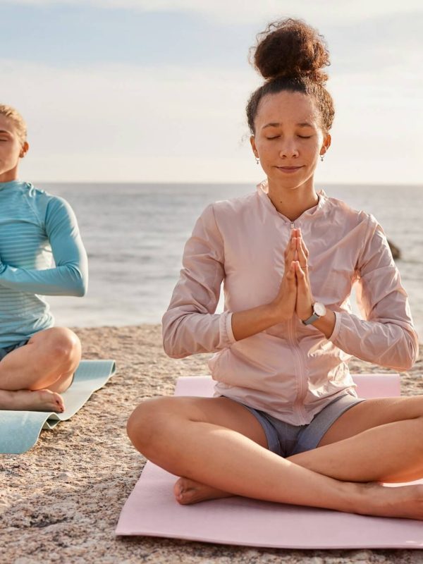 yoga-meditation-and-friends-outdoor-on-a-beach-together-for-mental-health-or-wellness-in-summer-e.jpg